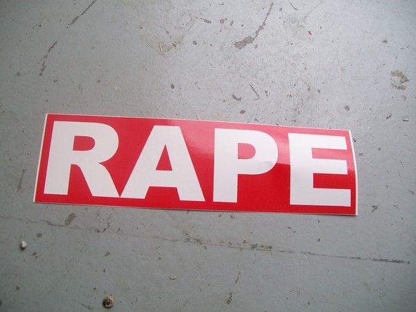 Stop sign sticker: Rape