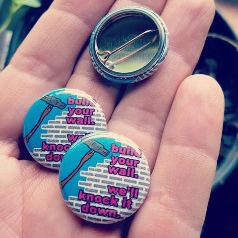 "build your wall. we'll knock it down." pin